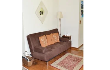 Full size futon, gleaming wood floors.