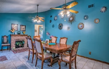 The roomy eating room seats 10 and features decorative fireplace.