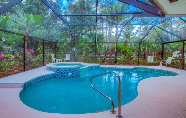 Heated Pool and Spa screened and surrounded by lush landscaping.
